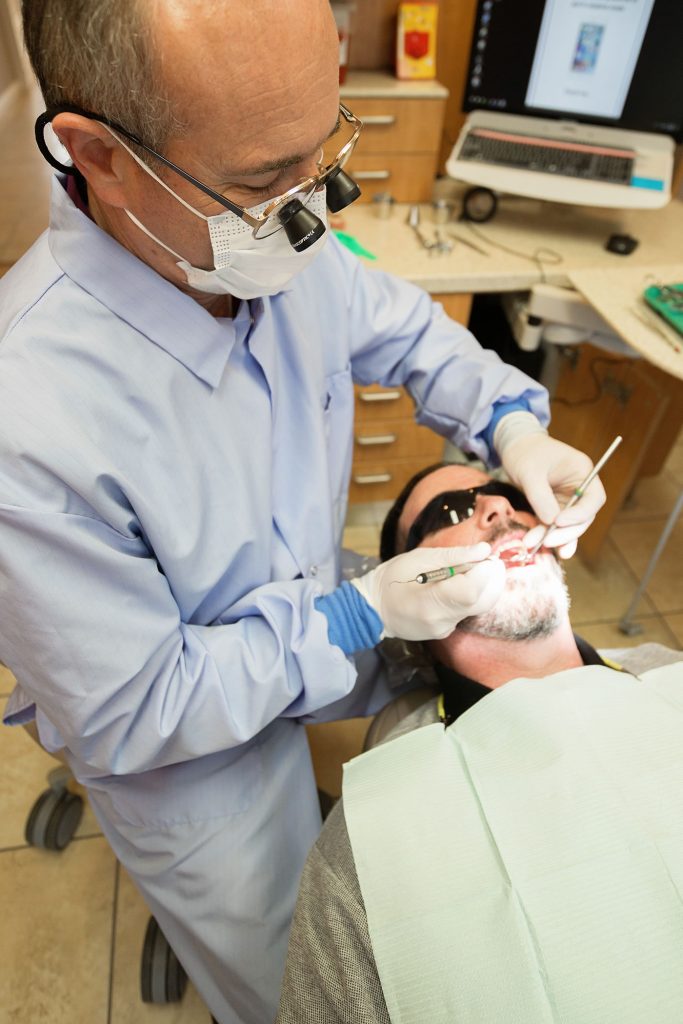 Dentist in Newport Oregon Performing an Exam